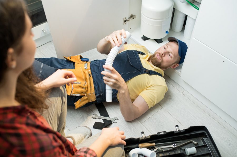 young-plumber-changing-trap-under-sink.jpg
